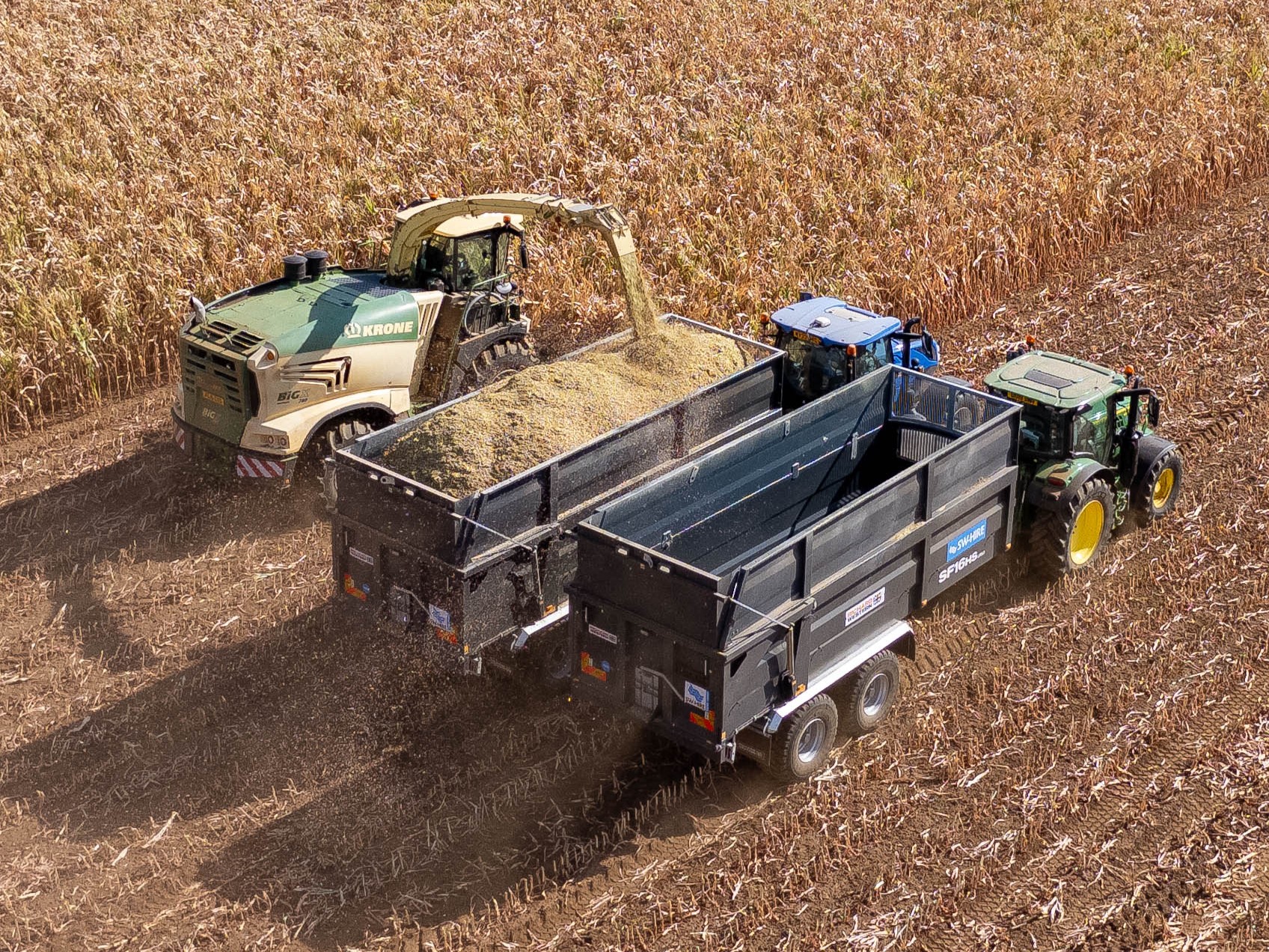 Two grey Richard Western SF16HS trailers filling up with maize from a krone forager